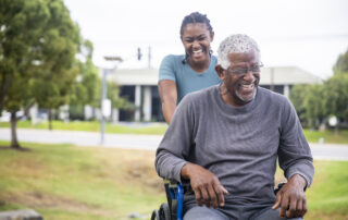 Senior black man in wheelchair with daughter